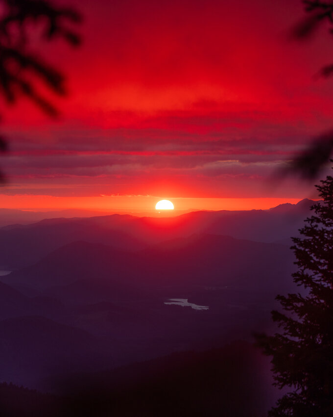 Clouds glow red as the sunset is seen from the Burley Mountain Trail on Thursday, Aug. 10, in the Gifford Pinchot National Forest.