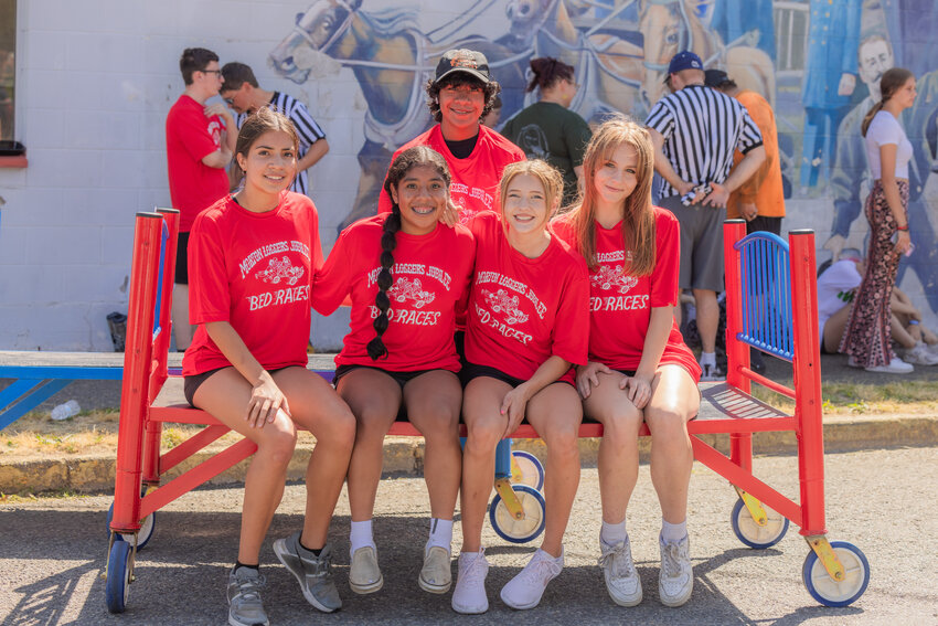 Mossyrock cheerleaders from left, Leah Contreras, Arleth Villalba, Martin Villalba, Jalyn Kolb and Hailey Edgington smile for a photo after taking first place during the Morton Loggers Jubilee bed races Saturday morning.