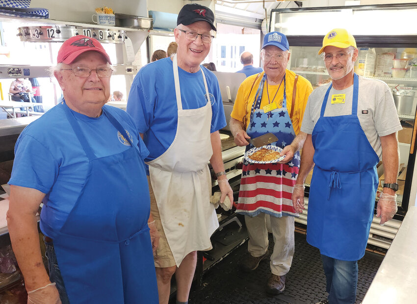 Ridgefield Lions Clyde Burkle, Dean Stenehjem, Joe Melroy and Rob Aichele work the kitchen at the fair booth.