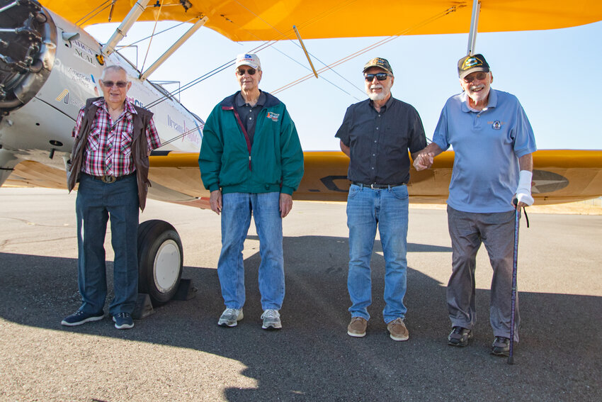 Starting on the left, veterans Jerry Blanchard, Wayne Reuter, Terry Dennis and Bill Huttula pose in front of a 1942 Boeing PT-17 Stearman plane on Monday before taking a flight in it courtesy of the nonprofit organization Dream Flights at the Chehalis-Centralia Airport on Monday, Aug. 14.