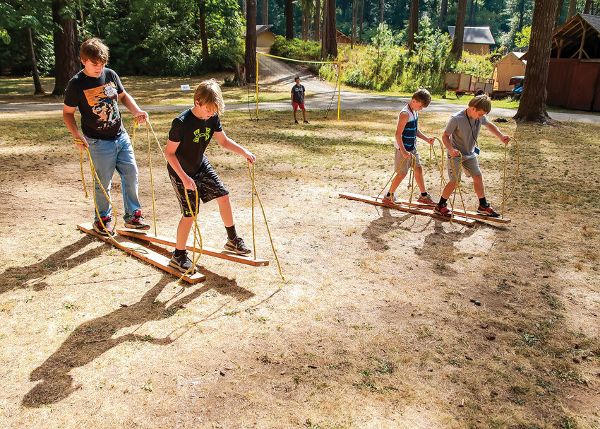 Kids at the Camp Hope of Southwest Washington CSI/STEM camp build teamwork skills by having to call out what side to move for their board to &ldquo;walk&rdquo; on Wednesday, Aug. 9.