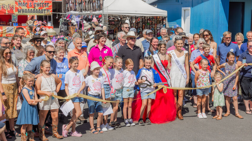 Little Miss Friendly Emma Britton smiles before cutting a ribbon to signify the official grand opening of the Southwest Washington Fair Tuesday morning.