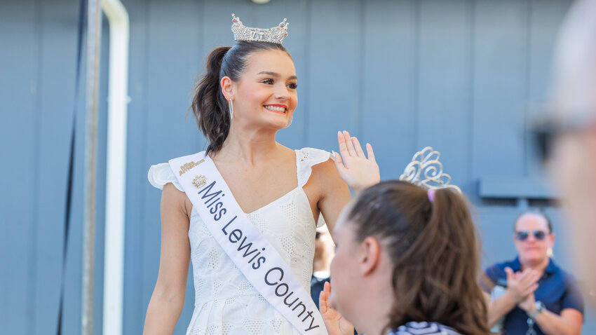 Miss Lewis County Myah O'Neill smiles and waves while attending a grand opening ceremony at the Southwest Washington Fairgrounds on Tuesday Aug. 15.