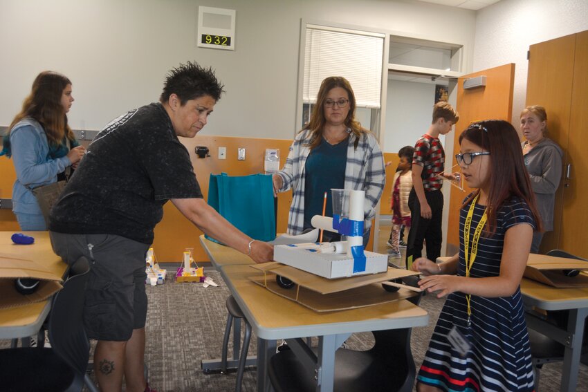 Students measure the magnitude of earthquakes using home-made seismographs at STEMKAMP Family Day on Aug. 11.