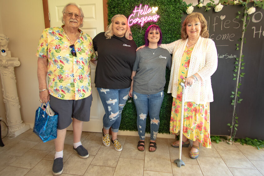Retiring owners Jim Stiltner, left, and Nonie Stiltner, right, pose for a picture with Appian Way Hair Care's new owners, Alexis Dickey, center left, and Cassey Zwiefelhofer, center right, during an open house celebration on Saturday, Aug. 12 celebrating the Stiltners' retirement and the new owners taking over.