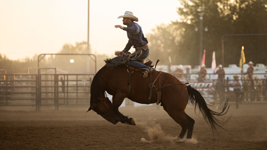 Ryan Verling, of Stanfield Oregon, rides a bucking bronc at the first night of the Southwest Washington Fair Rodeo on Wednesday, Aug. 16.