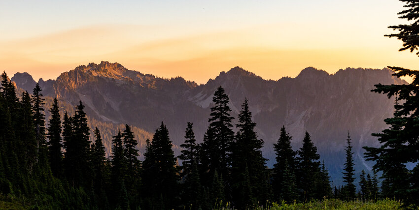 The Tatoosh Mountain Range glows during a hazy sunset from Paradise at Mount Rainier on Tuesday, Aug. 15.