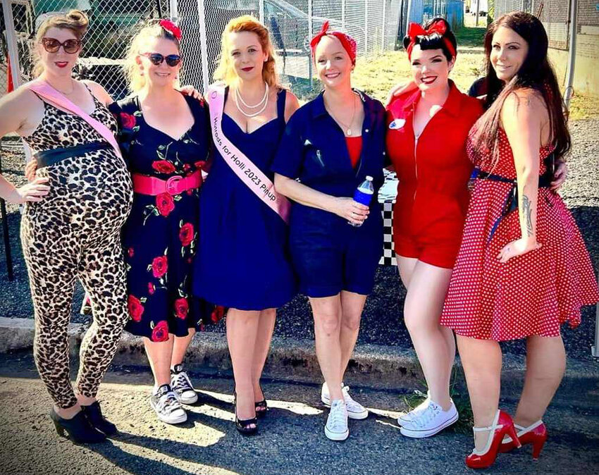 Holli McCain, center right, and Katy McCain, second from the right, pose for a picture with friends and pin-up contest participants at the Hot Rods for Holli benefit car show at the Veterans Memorial Museum on Sunday, Aug. 13. Photo courtesy of Katy McCain.