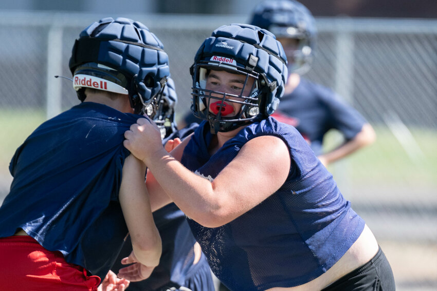 Max Whitehall blocks a defender during a drill at Black Hills' practice on Aug. 18.