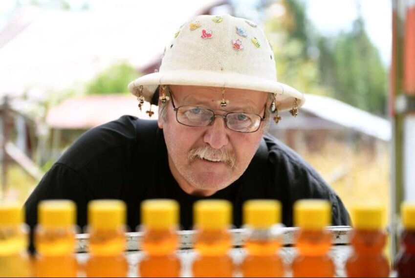 Rob Jenkins, owner of Bee Wrangler Honey and Bee Rescue, poses with his bee themed hat on Tuesday, July 25, at his homestead in Ethel, Washington. Jenkins has been keeping bees and producing honey-based products for 15 years.