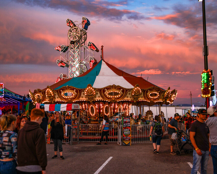 The sky blazes in a fiery sunset beyond the carousel in the carnival of the Clark County Fair on the opening night, Friday, Aug. 4.