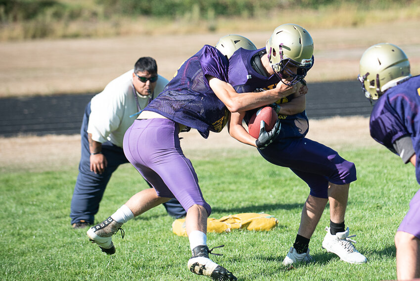 Coach Mazen Saade looks on as Cooper Lawrence tackles Mason Walters during Onalaska's practice on Aug. 21.