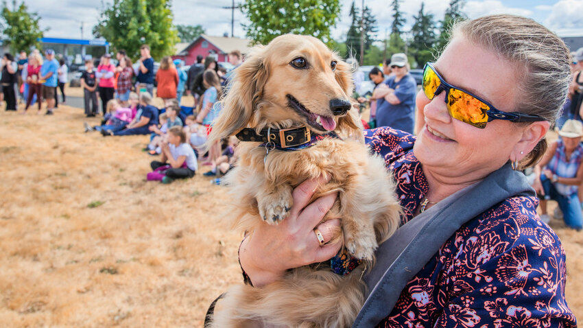 Caroline Castro, of Roy, smiles at Teddy after he took first place in the wiener races during last year's Rainier Round-Up Days celebrations.