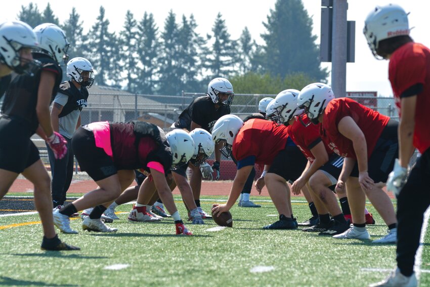 Members of the Tornados offensive and defensive lines prepare for a play at practice on Aug. 25.