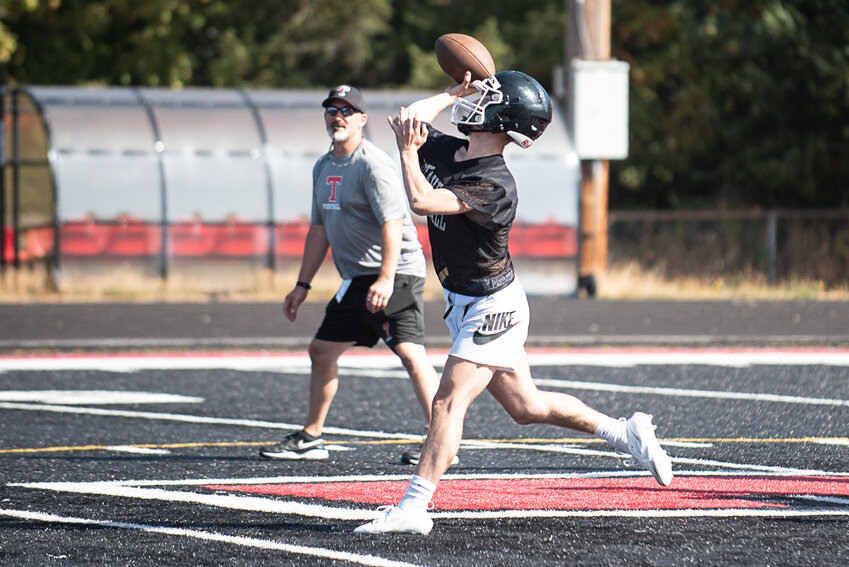 Quarterback Cody Strong launches a pass during Tenino's practice on Aug. 18.
