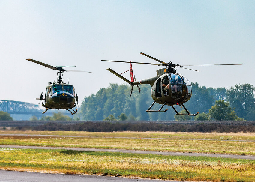 A Hughes OH-6 Cayuse &ldquo;Loach&rdquo; and a Bell UH-1 Iroquois &ldquo;Huey&rdquo; come in for a landing at the Southwest Washington Regional Airport for the third annual fly-in event at Cascade Air in Kelso on Sunday, Aug. 27. The aircraft are from The National Wings and Armor Foundation out of North Clark County.