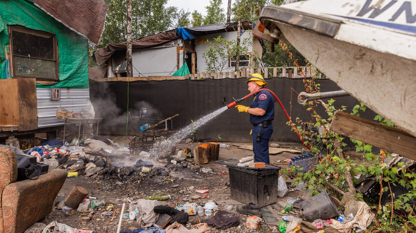 The Riverside Fire Authority responds as a fire dies out inside a homeless encampment at the end of Eckerson Road in Centralia on Tuesday, Sept. 5.