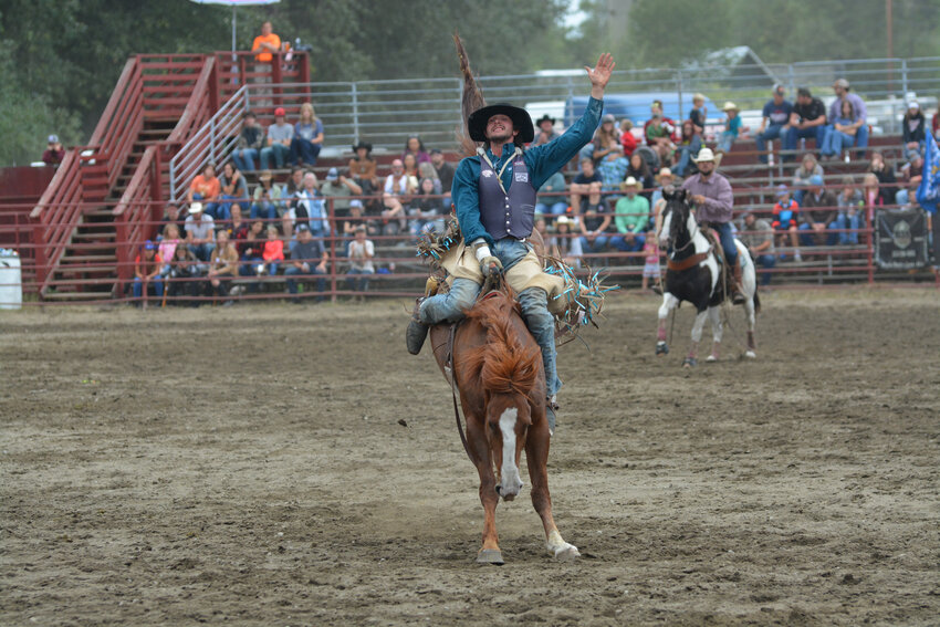 A cowboy holds on as his bronc bucks at the Roy Rodeo on Sept. 3, 2023.