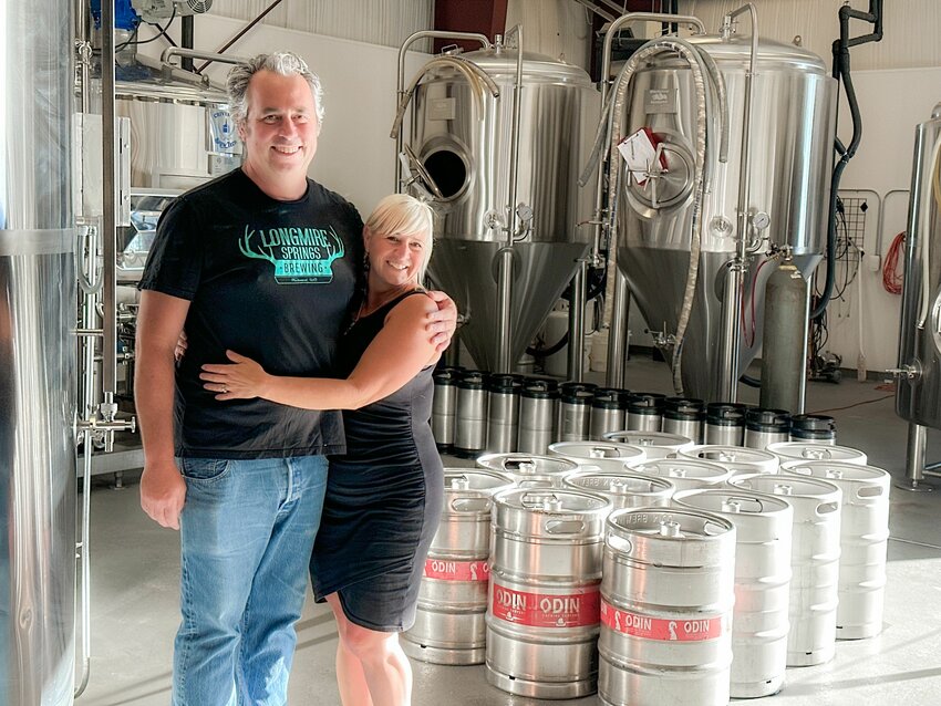 Owners Peter Charbonnier and Amy Besunder smile for a photo inside Longmire Springs Brewing in Packwood on Thursday, Aug. 10.