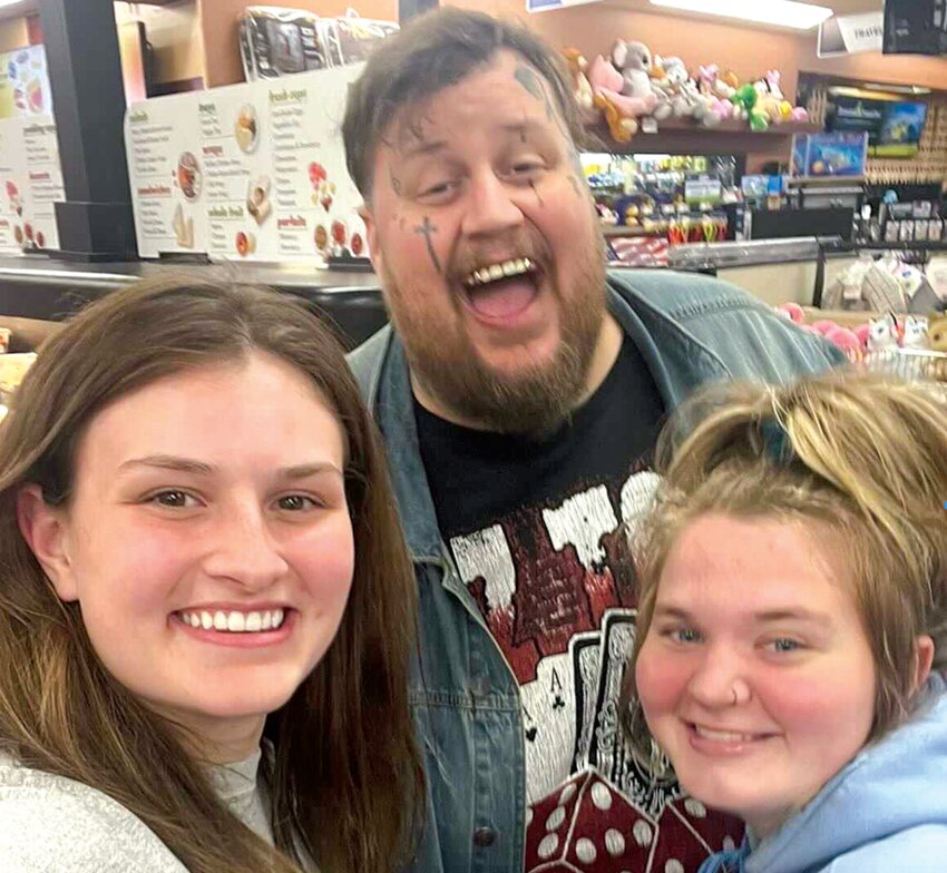 Evie Thomas, left, and Sadie Burdick, right, pose for a photo with Jelly Roll, real name Jason DeFord, at Love&rsquo;s Travel Stop in Napavine at about 2 a.m. Saturday, Sept. 9.