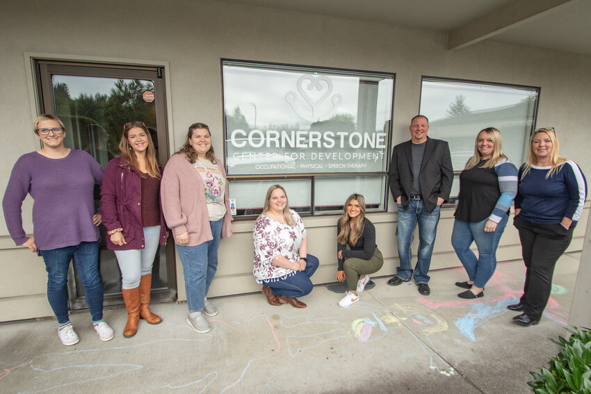Nick Robbins, third from the right, and his wife Sarah, fifth from the right, pose for a picture with their staff at the newly opened Cornerstone Center for Development, located at 1611 Kresky Ave., suite 108 in Centralia, on Friday, Sept. 8.