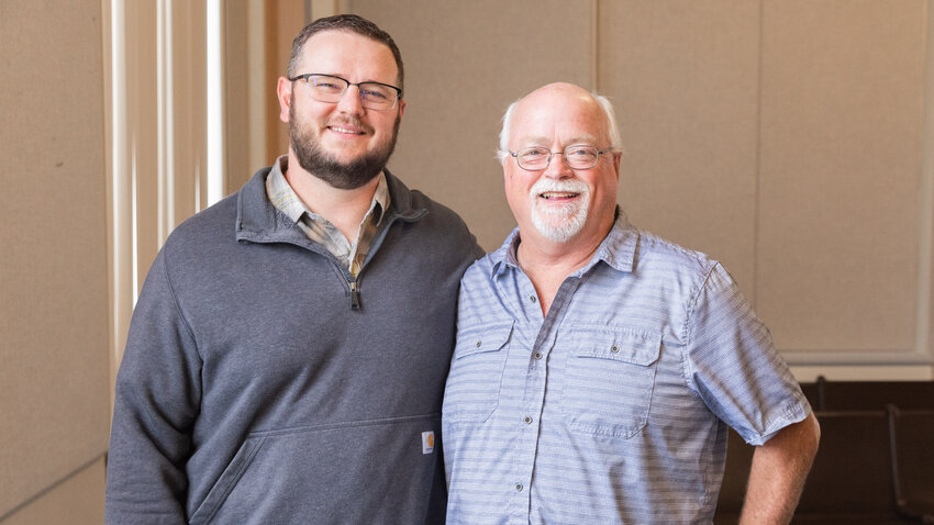 Geoff Soderquist, left, smiles for a photo alongside fellow Lewis County Engineer Tim Fife during Fife&rsquo;s last public meeting before retirement in Chehalis on Tuesday, Sept. 19.