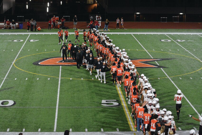 Members from the Yelm Tornados and Central Kitsap Cougars shake hands on Sept. 15 after Yelm was victorious, 56-6.