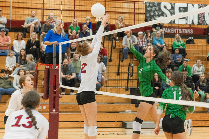 Tumwater&rsquo;s Paige Henderson (9) hits the ball as W.F. West&rsquo;s Chloe Chloupek (2) leaps up during a match in Chehalis on Tuesday, Sept. 19.