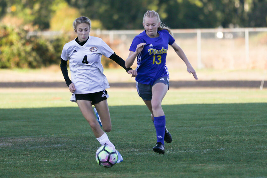 Napavine's Grace Pancake and Adna's Ava Humphrey chase down a ball during the Tigers' 1-1 draw with the Pirates, Sept. 20 in Adna.