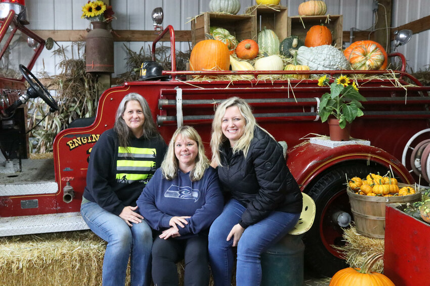 From left, The Pumpkin Patch staff Stacie Kinne, Carri Crockett and Candi Danielson pose for a photo on Sunday, Sept. 24 during opening weekend for Centralia pumpkin patch&rsquo;s 2023 season.