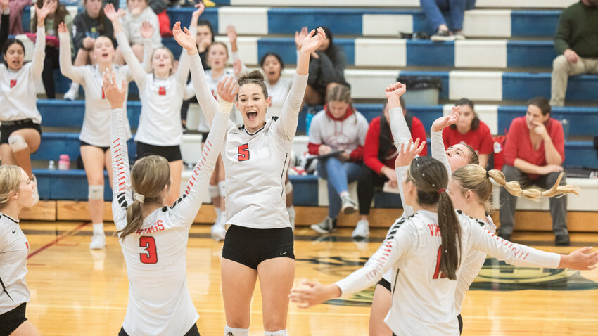 Vikings celebrate a point during a match against the Trojans on Tuesday, Sept. 26, in Pe Ell.