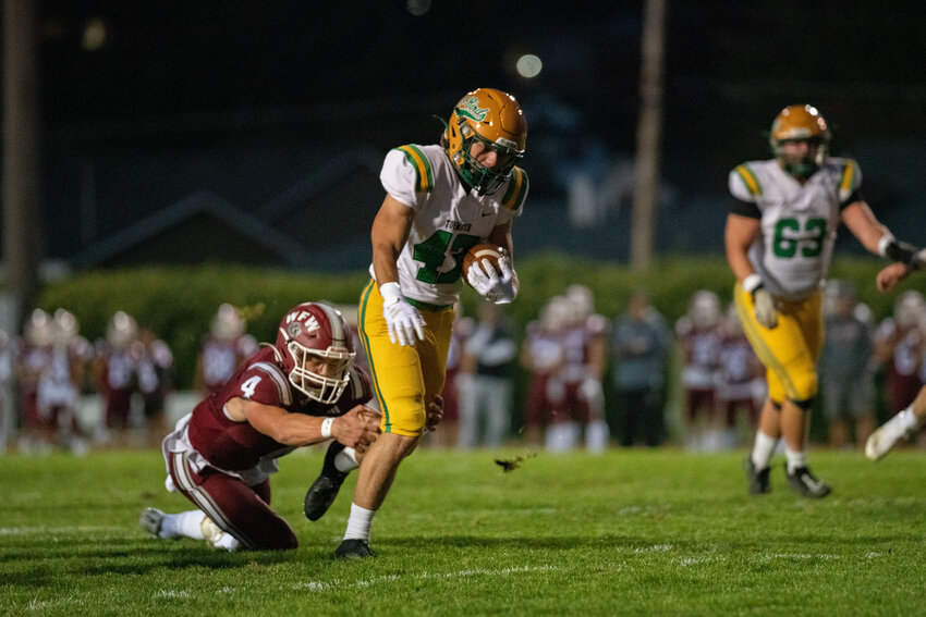 Tumwater's Mathias Rodriguez runs through an arm tackle on his way to the end zone during the first half of Tumwater's game at W.F. West on Sept. 29.