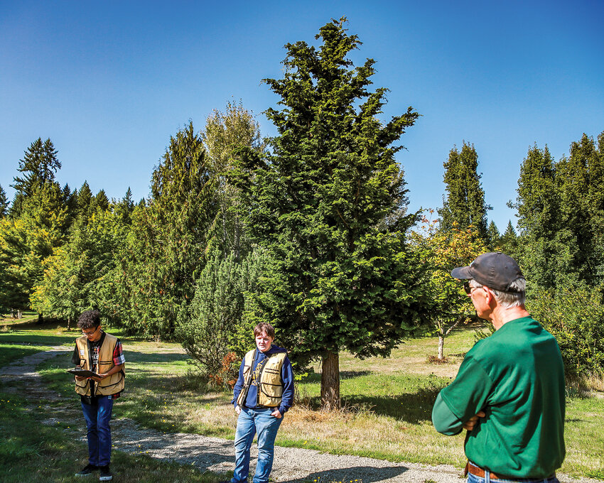 CASEE Center founder Mark Watrin, right, listens as current students give a tour of the westside&rsquo;s arboretum during a 30th anniversary celebration on Saturday, Sept. 30.