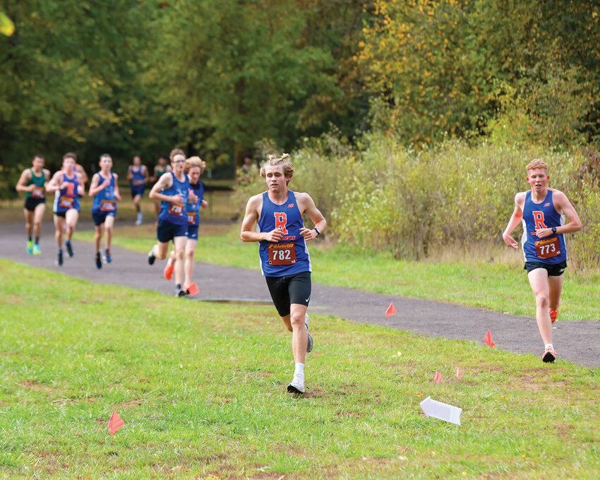 Ridgefield junior Davis Sullivan, wearing No. 782, leads the pack on his way to a cross country victory at Hockinson Meadows Community Park in a meet between Ridgefield, Woodland and Hockinson high schools on Wednesday, Sept. 27.