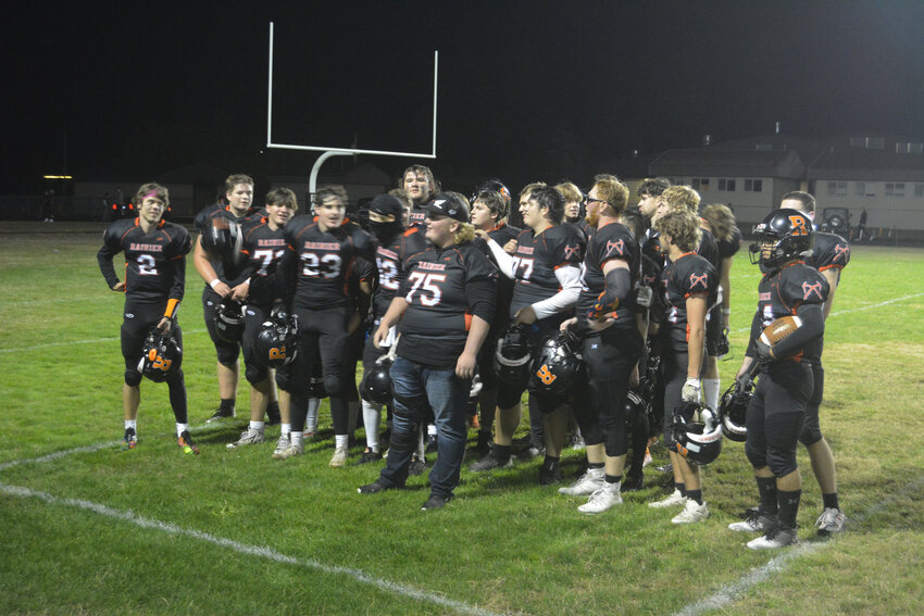 Rainier football players sing the fight song after a win against Ilwaco on Sept. 29.
