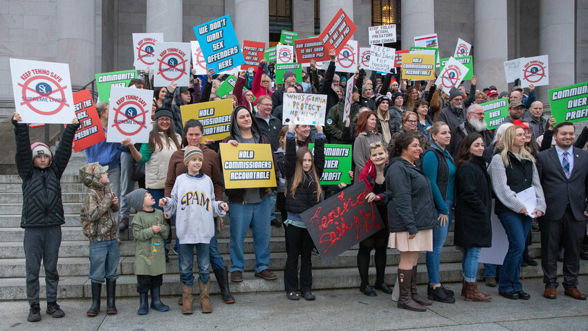 Tenino area residents gather for a photo while protesting proposed sex offender housing outside the Washington State Capitol building in Olympia in 2023.
