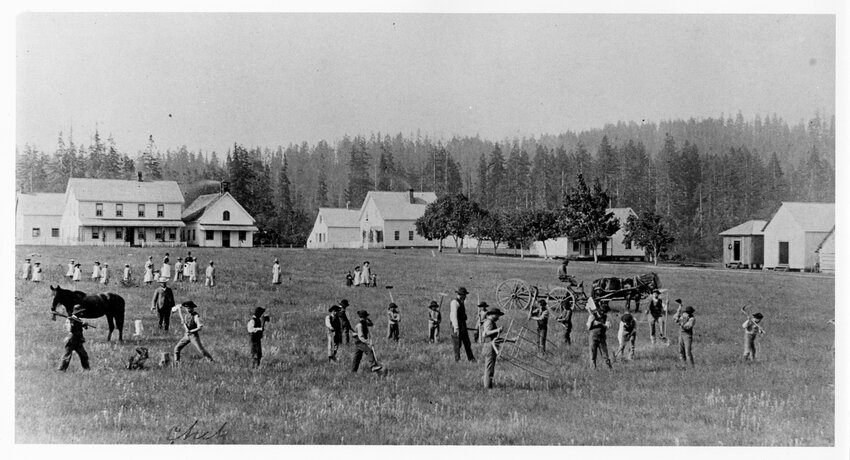 Native American children are pictured in a field in front of the Chehalis Indian School in Oakville in this 1885 photograph from the Washington State Archives.