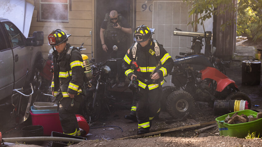 Centralia police and crews from Riverside Fire Authority respond to a scene along South Pleasant Avenue after flames scorched two motorcycles next to a home in Centralia on Wednesday, Oct. 4.