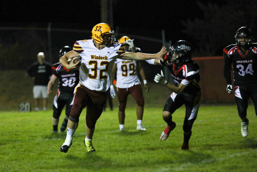James Cusson stiff-arms a defender during Winlock's game at Oakville on Oct. 6.