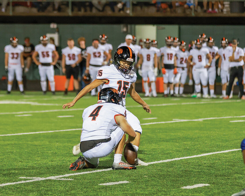 Battle Ground&rsquo;s Jacob Champine holds the ball for sophomore kicker Bryland Fick as Fick was 3 for 3 on field goals with kicks from 35 yards, 41 yards and 27 yards as the Tigers shut out Lakes High School of Lakewood 23-0 on Friday, Oct. 6.