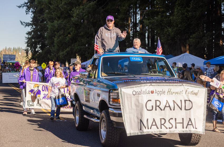 Grand Marshal Bob Dow smiles and waves during the Onalaska Apple Harvest Festival parade on Saturday, Oct. 7.