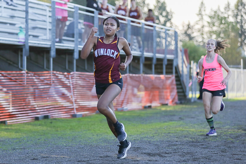 Winlock's Victoria Sancho beats Tenino's Samantha Smith in a sprint for second place at a cross country meet at Winlock on Oct. 12, 2023.