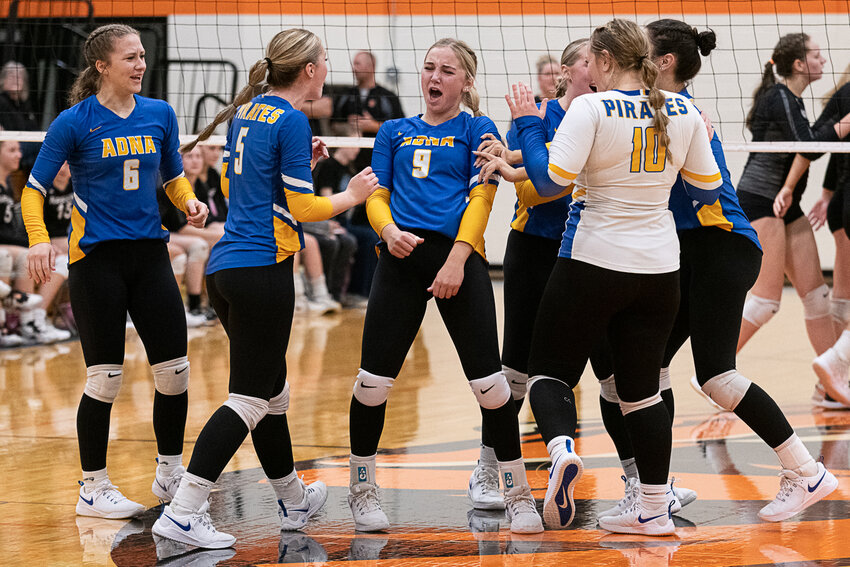 Danika Hallom (9) and the Adna Pirates celebrate after scoring a point in their win over Napavine on Oct. 12.