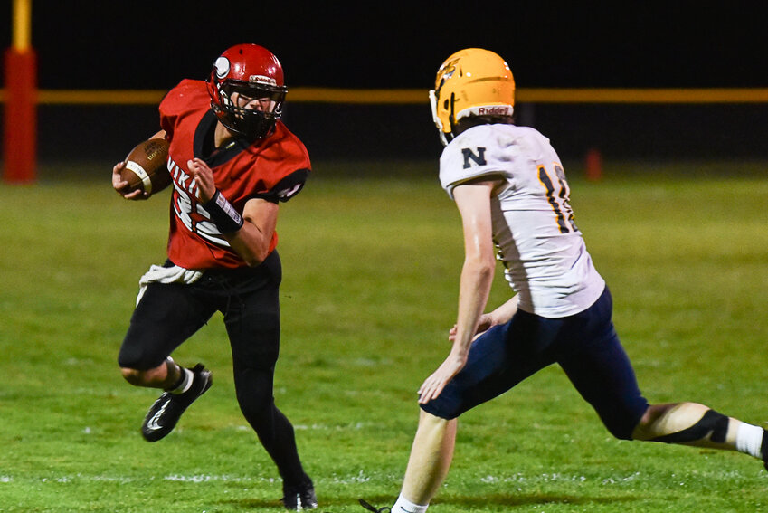 Hunter Isom prepares for contact as he approaches a Naselle defender during Mossyrock's win on Oct. 13.