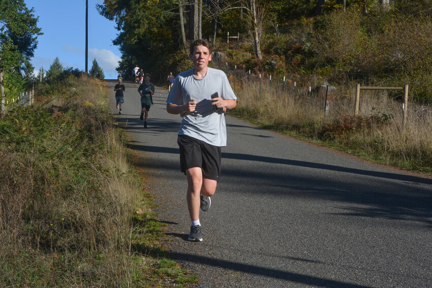 Freshman Caleb Stover runs during practice outside Fire Station 24 in Rainier on Oct. 12.