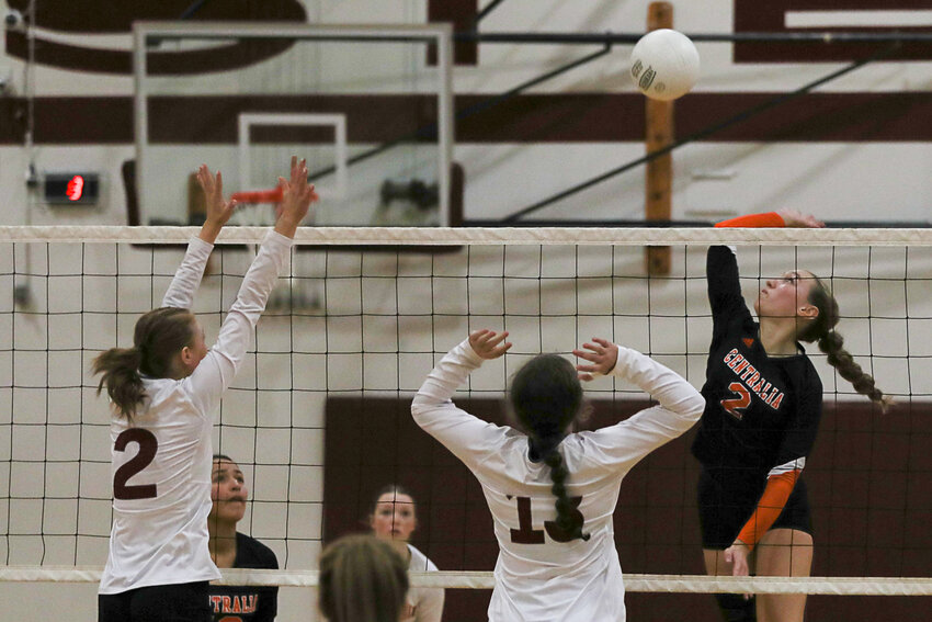 Lauren Wasson spikes the ball over two leaping W.F. West defenders during Centralia's victory on Oct. 17.