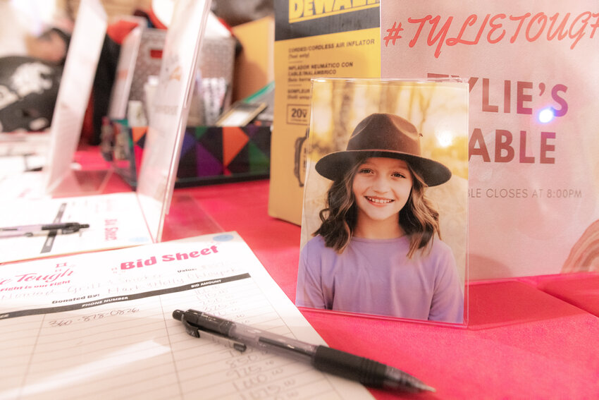 A picture of Tylie Tobin, a 10-year-old with a rare form of cancerous tumor on her brain stem, sits on display inside the Old Mill Farm in Onalaska during a benefit dinner on Saturday, Oct. 21.