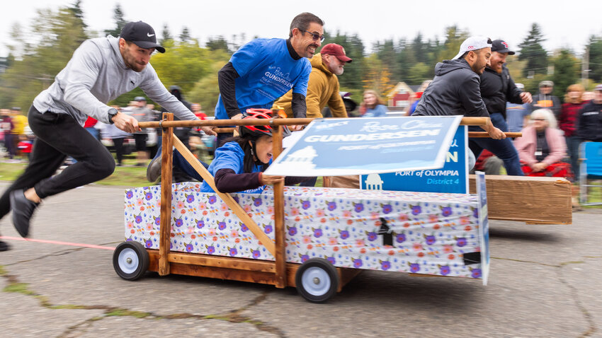 Attendees race to the finish line during the Boo-Coda casket races on Saturday, Oct. 21.
