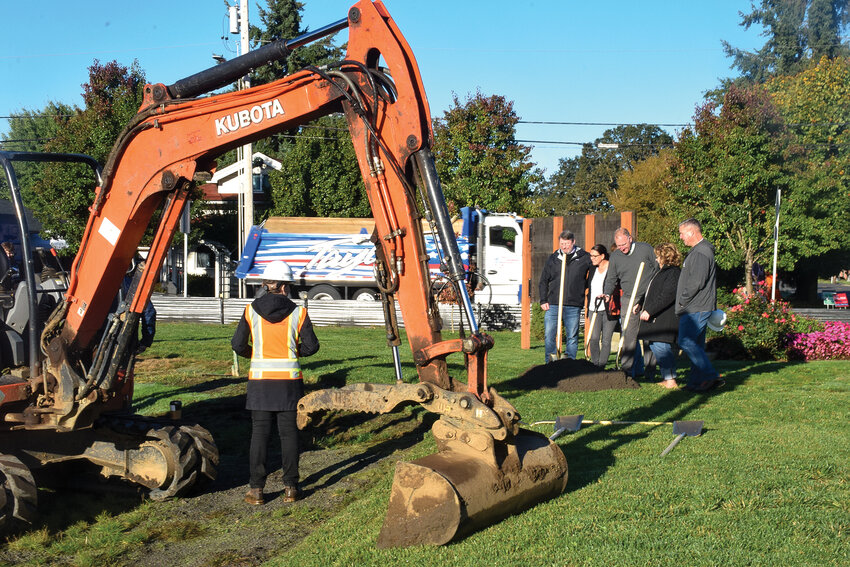 Woodland officials and construction workers stand by a ceremonial pile of dirt for the groundbreaking of the Woodland Civic Center Oct. 18.