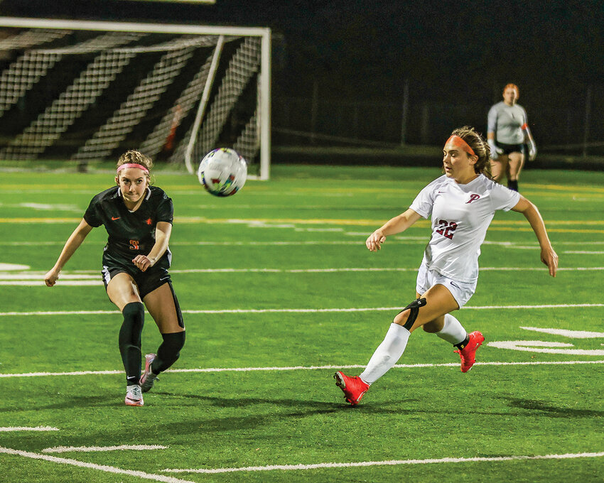 Battle Ground&rsquo;s Isabella Brenes kicks the ball downfield with Prairie&rsquo;s Avery Hoskins nearby on defense during the district rivals&rsquo; 0-0 draw on Tuesday, Oct. 17.